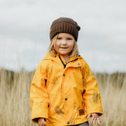 Girls raincoat - Girl wears mustard yellow Wild Island kids waterproof rain jacket outdoors 
