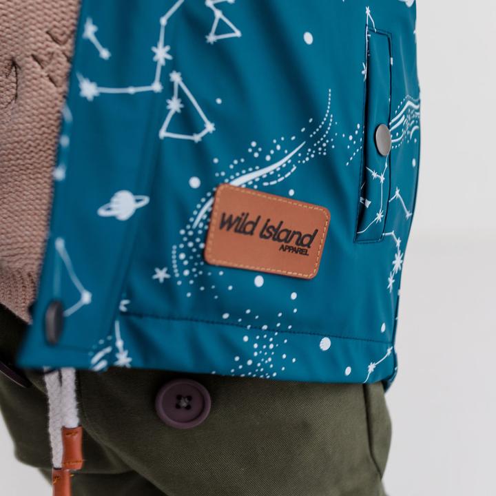 Brand vegan leather label detail on Wild Island children's raincoat.