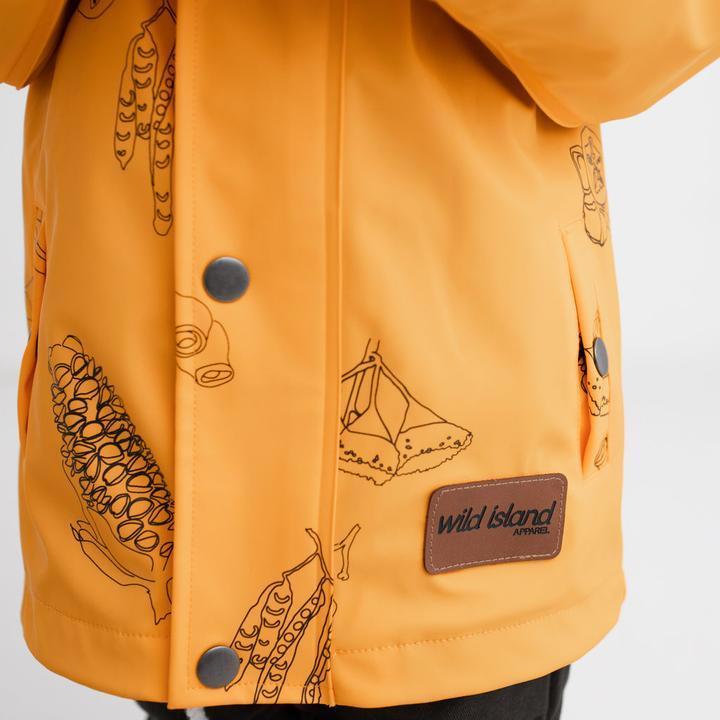 Kids waterproof jacket in mustard yellow with Australian seed pods print and Wild Island brand patch 