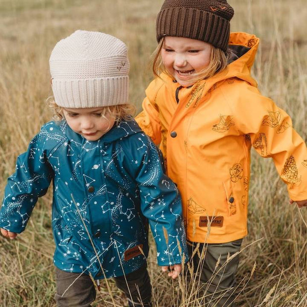 Boy and girl wear kids printed raincoat with Australian constellation print outside.